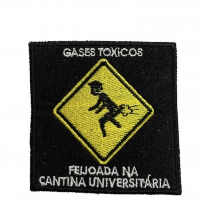 Patch de tecido preto com bordado amarelo e branco sobre gases tóxicos