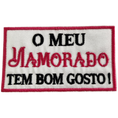 Emblema retangular com texto bordado em preto e vermelho num fundo branco
