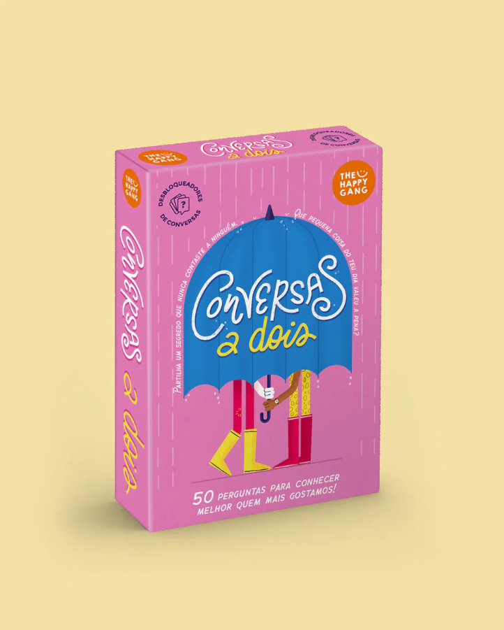 Conversas a Dois Happy Gang Caixa de jogo Conversas à Dois com guarda-chuva azul e texto em rosa e amarelo
