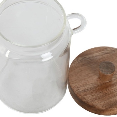 Pote de vidro transparente com tampa de madeira ao lado