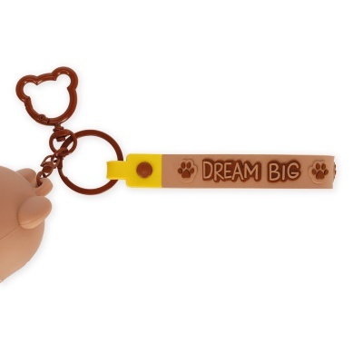 Chaveiro com fecho em forma de cabeça de urso e correia em silicone com a frase DREAM BIG e patas de urso.