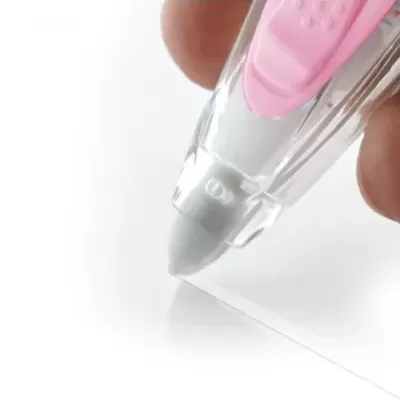 Corrector em fita transparente e rosa a ser usado sobre papel