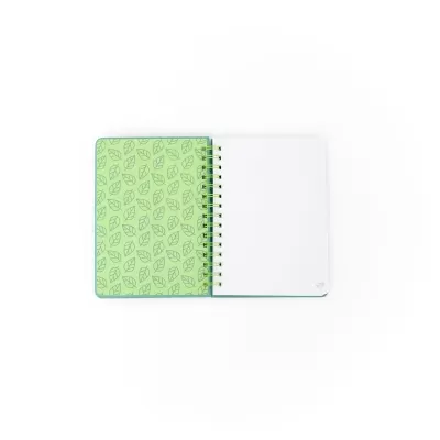Caderno aberto com capa verde e padrão de folhas azuis