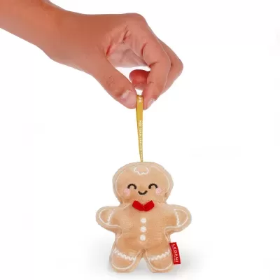 Boneco de peluche em forma de biscoito gingerbread com laço vermelho