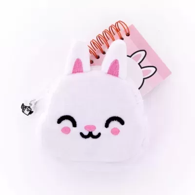 Caderno pequeno com capa em forma de rosto de coelho branco e espiral laranja