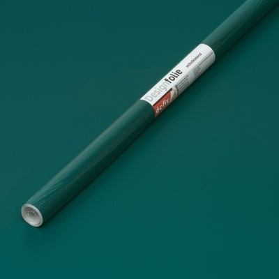 Rolo de vinil adesivo verde escuro com etiqueta branca em fundo verde.