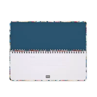 Agendador colorido com espiral metálica aberta mostrando página interna para anotações