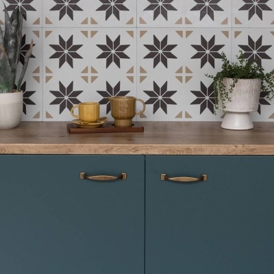 Tampo de madeira com armários verdes, canecas castanhas, plantas em vasos brancos e azulejos decorativos