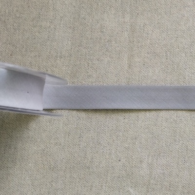 Fita elástica branca com etiqueta Cor 12 sobre tecido bege