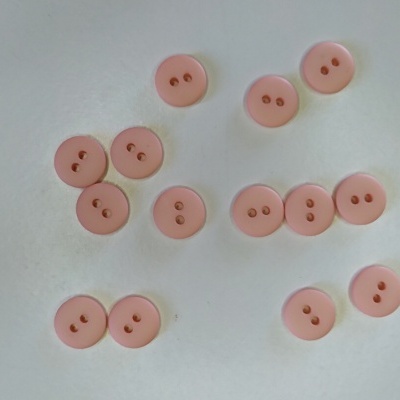 Botões redondos rosa claro com dois orifícios