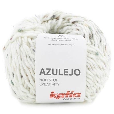 Novelo de lã branca com pontos coloridos e rótulo Katia Azulejo