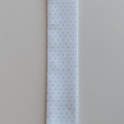 Tira branca com botão e clipe e letra A preta no fundo