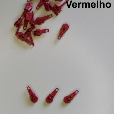 Puxadores de zíper vermelhos dispostos sobre fundo branco com texto 'Vermelho'.