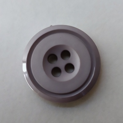 Botão redondo cinzento com quatro furos no centro