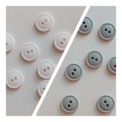 Botões redondos brancos e cinza claro de dois furos em fundo branco