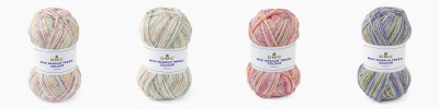 quatro novelos de lã colorida com etiquetas DMC COCOON