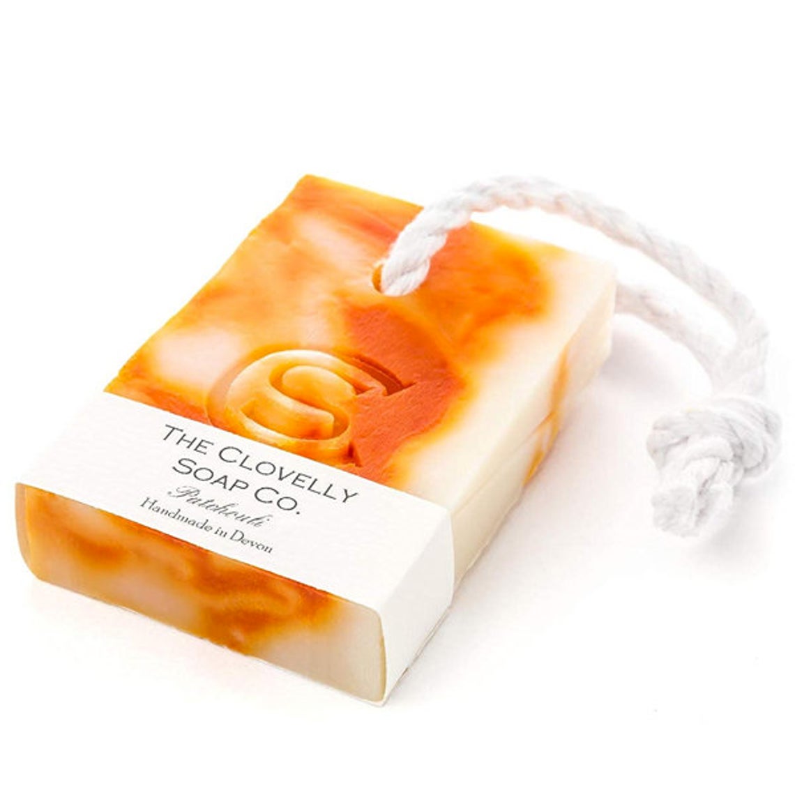 Barra de sabão com tons laranja e branco e cordão branco