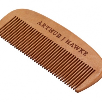 Pente de madeira castanha clara com texto gravado