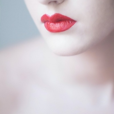 Rosto com lábios vermelhos focados e pele clara