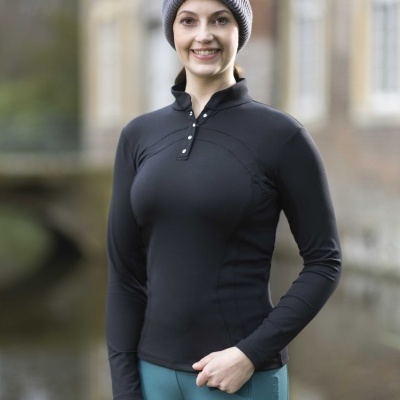 Mulher com roupa desportiva e chapéu cinzento de malha posando ao ar livre