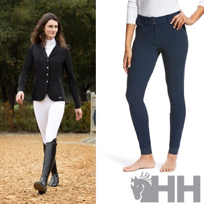 Calças de equitação azul-escuras com fecho e cinto, mulher com casaco preto e botas pretas em ambiente de equitação