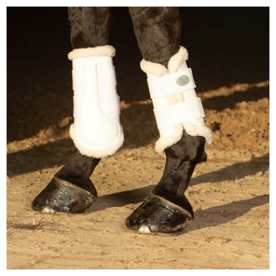 Botas brancas para pernas de cavalo com forro macio em ambiente com chão de terra