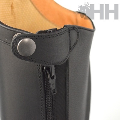 Parte superior de uma bota preta com fecho e botão metálico