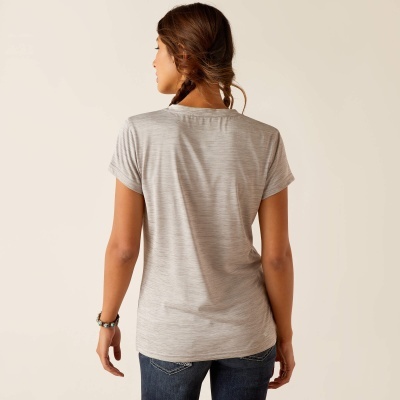 Mulher de costas com t-shirt cinza de riscas finas e jeans azul