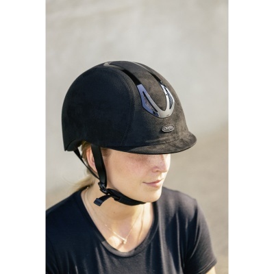 Capacete de equitação preto usado por mulher com camisola preta