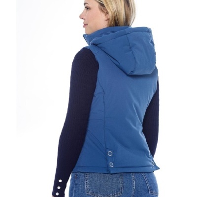 Colete azul acolchoado com capuz visto de costas, usado sobre camisola preta e jeans azuis