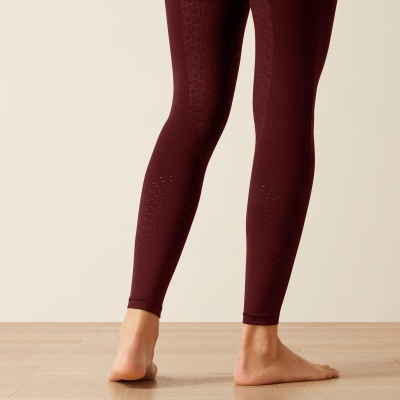 Leggings vinho com textura listrada e relevos circulares na parte inferior da perna