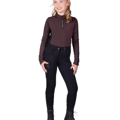 Menina de top castanho escuro e calças pretas com botas pretas