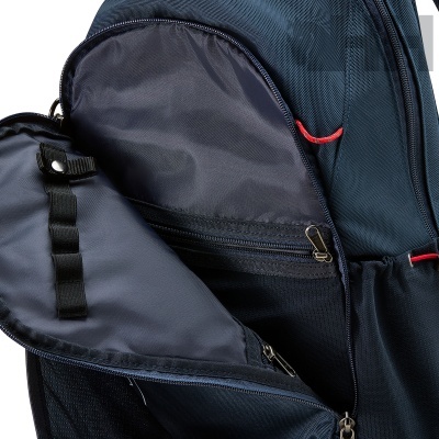 Mochila azul escura aberta mostrando compartimentos interiores com fechos de correr