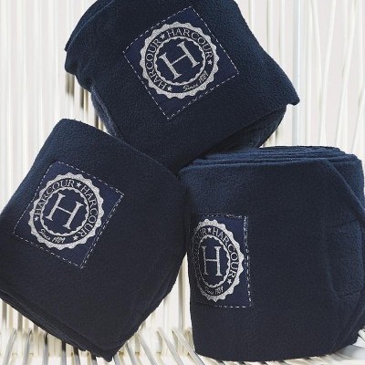 Ligaduras azuis com etiqueta HARCOUR colocadas sobre superfície branca ripada