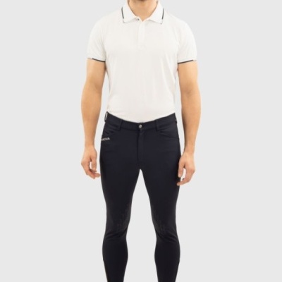 Homem vestido com polo branca e calças pretas justas com sapatos brancos
