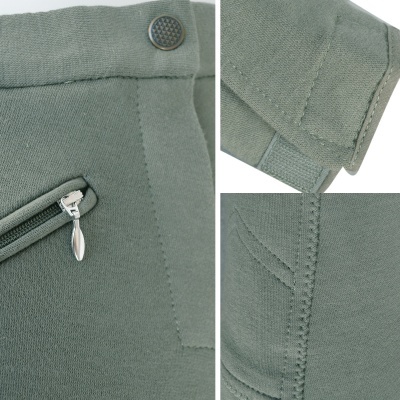 Detalhes de peça de roupa verde-acinzentada com bolso com fecho e botão metálico