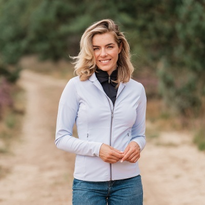 Mulher com casaco azul claro e calça de ganga no exterior