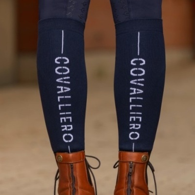 Perneiras azuis com palavra COVALLIERO e botas de couro castanhas