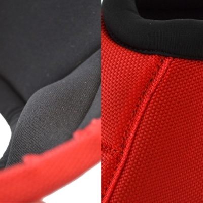 Detalhe de tecido vermelho texturizado com tecido preto liso e costuras visíveis