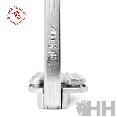 Estribos metálicos prateados com texto Tech Stirrups e símbolo Shock Absorbing System