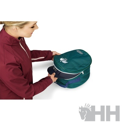 Bolsa verde com boné azul escuro sendo segurado por pessoa com casaco vinho.