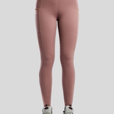 Leggings rosa antigo com bolsos laterais e padrão de pontos.