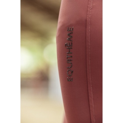 Legging rosa queimado com palavra EQUITHÈME em cristais pretos.