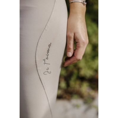 Saia bege com assinatura decorativa e braço com pulseira