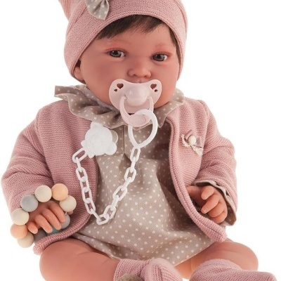 Boneca bebé com roupas rosas e bege, chupeta e mordedor.