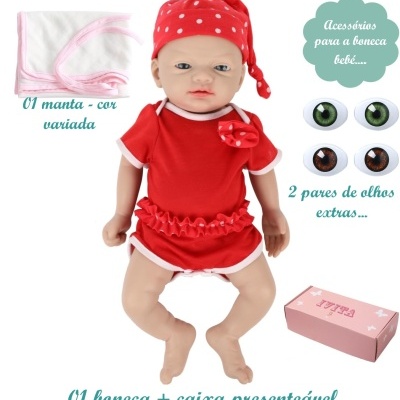 Boneca bebê vestida de vermelho com gorro, manta branca, olhos extras e caixa rosa.