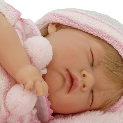 Boneca bebé realista com roupão rosa e pompons a dormir