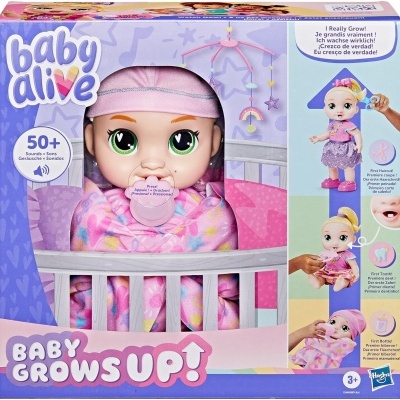 Boneca bebé Baby Alive envolvida em manta colorida numa embalagem com berço branco