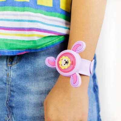 Pulseira infantil lilás com carinha de leão rosa no pulso de criança com roupa colorida