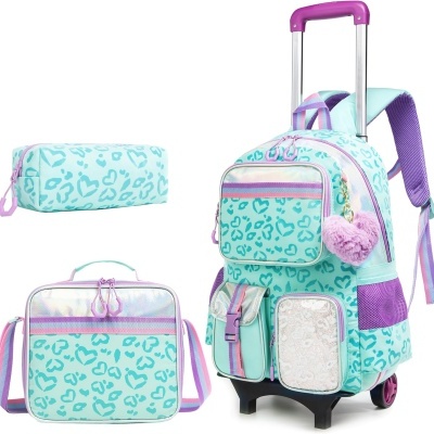 Conjunto mochila escolar de rodinhas, lancheira e estojo azul claro com padrão de manchas e detalhes violeta